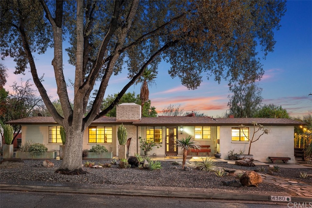 4380 Isabella Street Riverside, CA 92501 - Photo 1 of 1 a large tree in front of a house