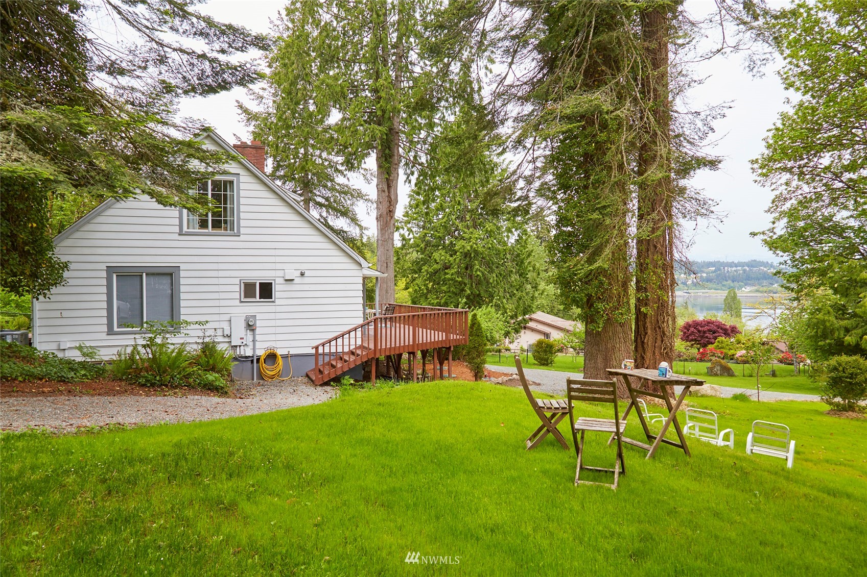 a backyard of a house with table and chairs