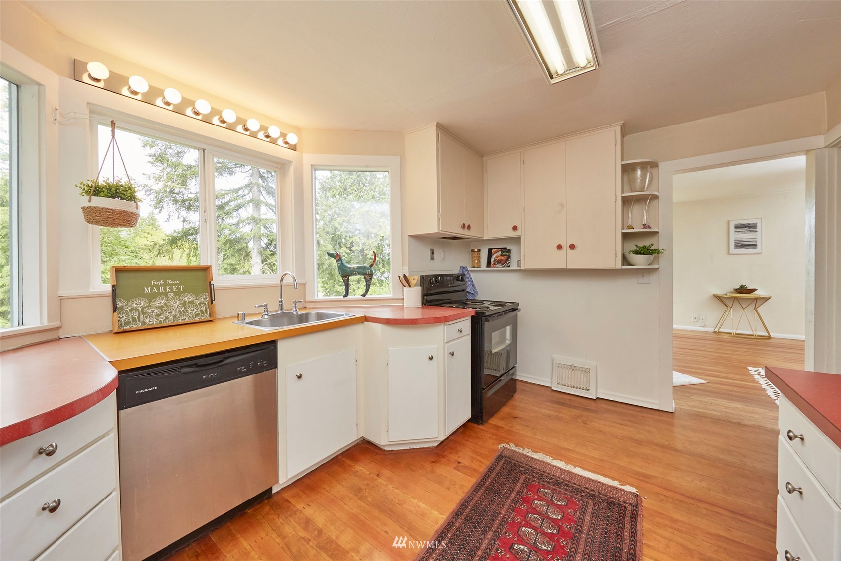 1446 Dogwood Hill Road Southwest Port Orchard, WA 98366 - Photo 13 of 31 a kitchen with a sink stove and wooden cabinets