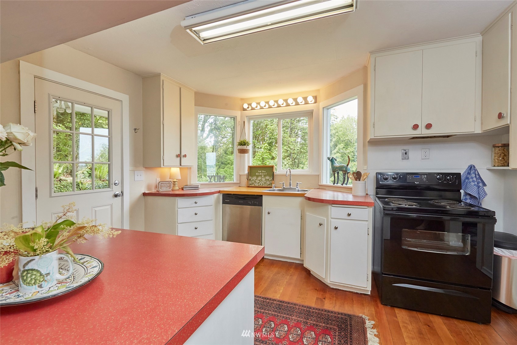 1446 Dogwood Hill Road Southwest Port Orchard, WA 98366 - Photo 15 of 31 a kitchen with stainless steel appliances granite countertop a stove a sink and a refrigerator