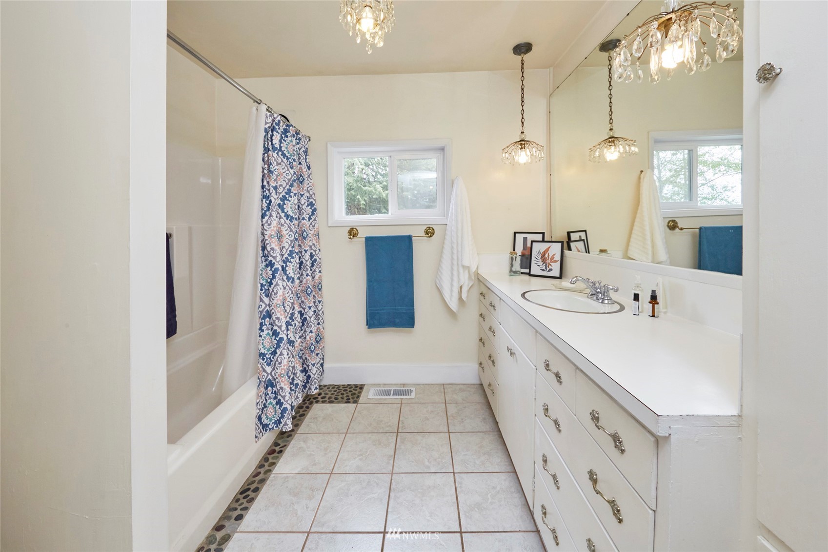 1446 Dogwood Hill Road Southwest Port Orchard, WA 98366 - Photo 23 of 31 a spacious bathroom with a double vanity sink a large mirror and shower