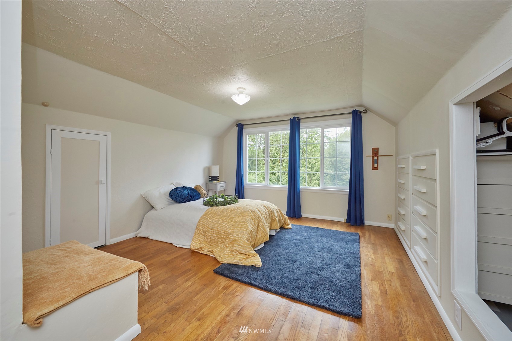 1446 Dogwood Hill Road Southwest Port Orchard, WA 98366 - Photo 28 of 31 a bedroom with a large bed and wooden floor