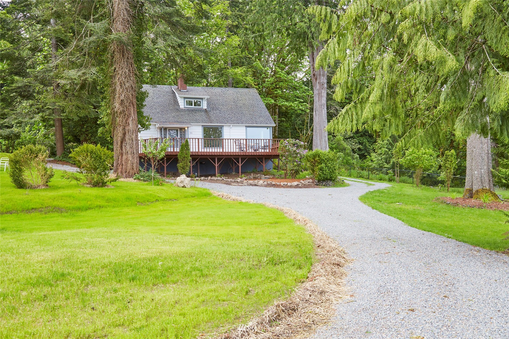 1446 Dogwood Hill Road Southwest Port Orchard, WA 98366 - Photo 7 of 31 a view of a house with garden and a bench
