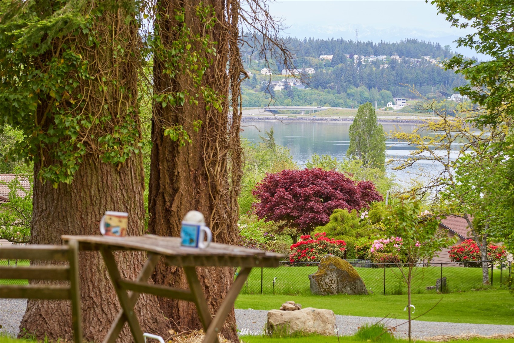 1446 Dogwood Hill Road Southwest Port Orchard, WA 98366 - Photo 10 of 31 a view of a lake with a bench and a yard