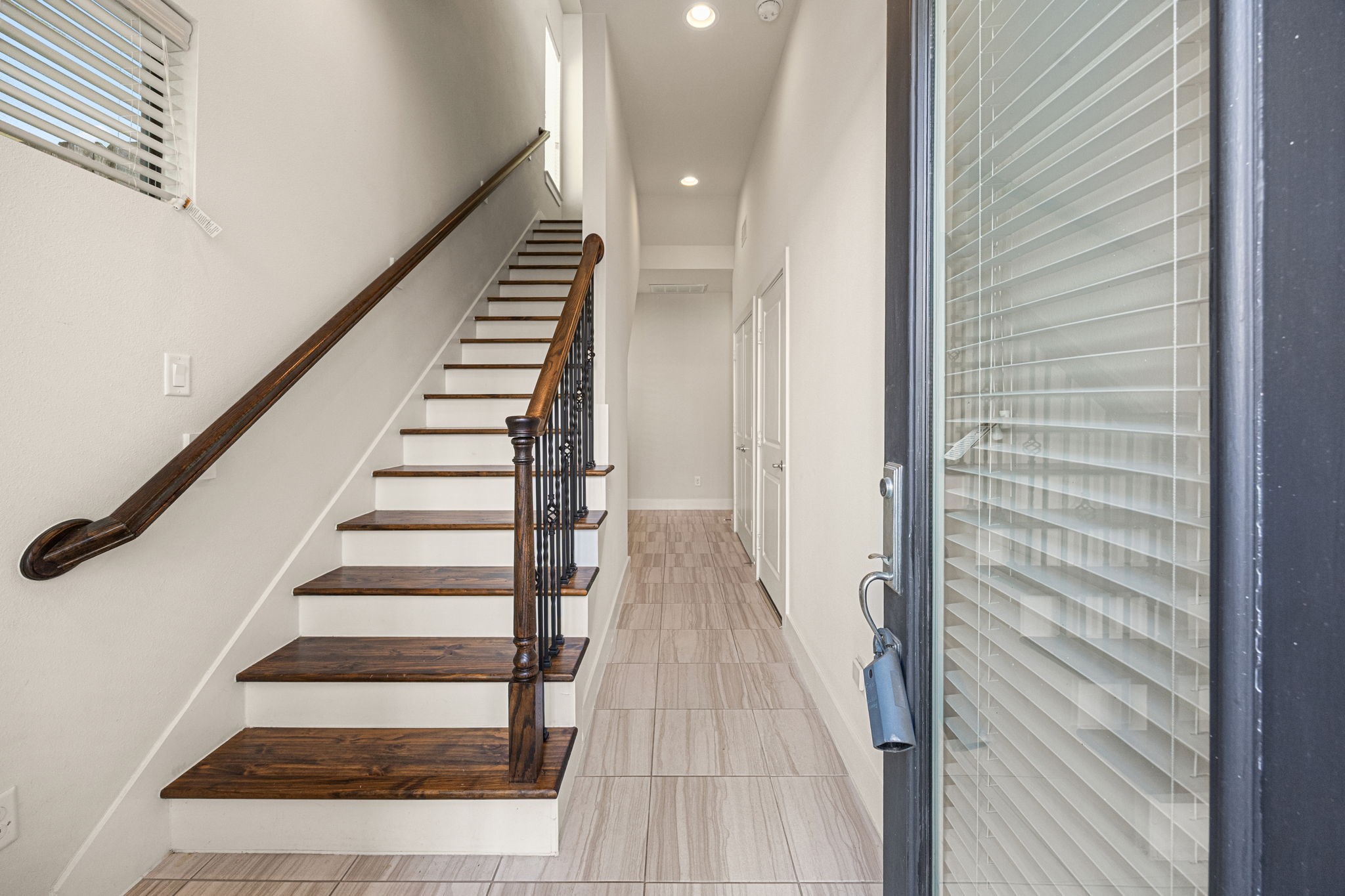 3945 Tulane Street Houston, TX 77018 - Photo 2 of 26 a view of a hallway with wooden floor and staircase