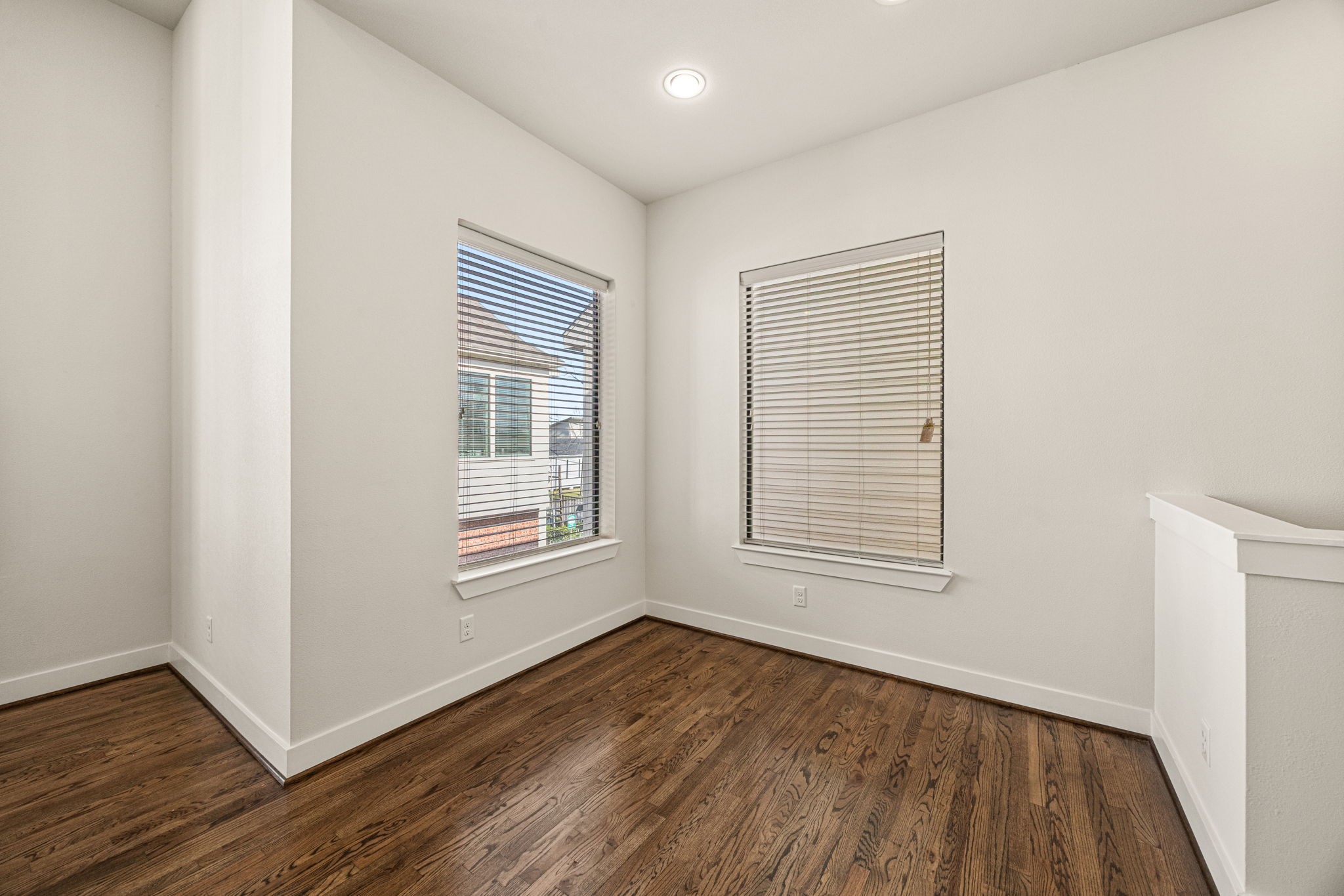 3945 Tulane Street Houston, TX 77018 - Photo 10 of 26 an empty room with wooden floor and windows
