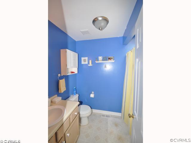 2525 Brookforest Road Midlothian, VA 23112 - Photo 8 of 11 a bathroom with a granite countertop toilet and a sink
