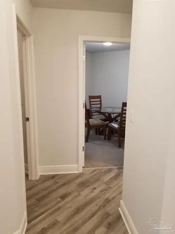 a bathroom with a granite countertop sink toilet and mirror