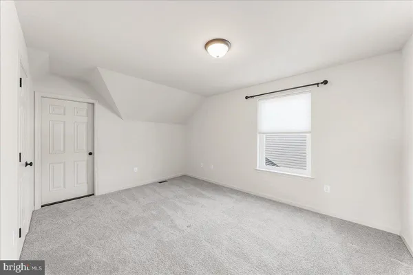 an empty room with a empty space and windows