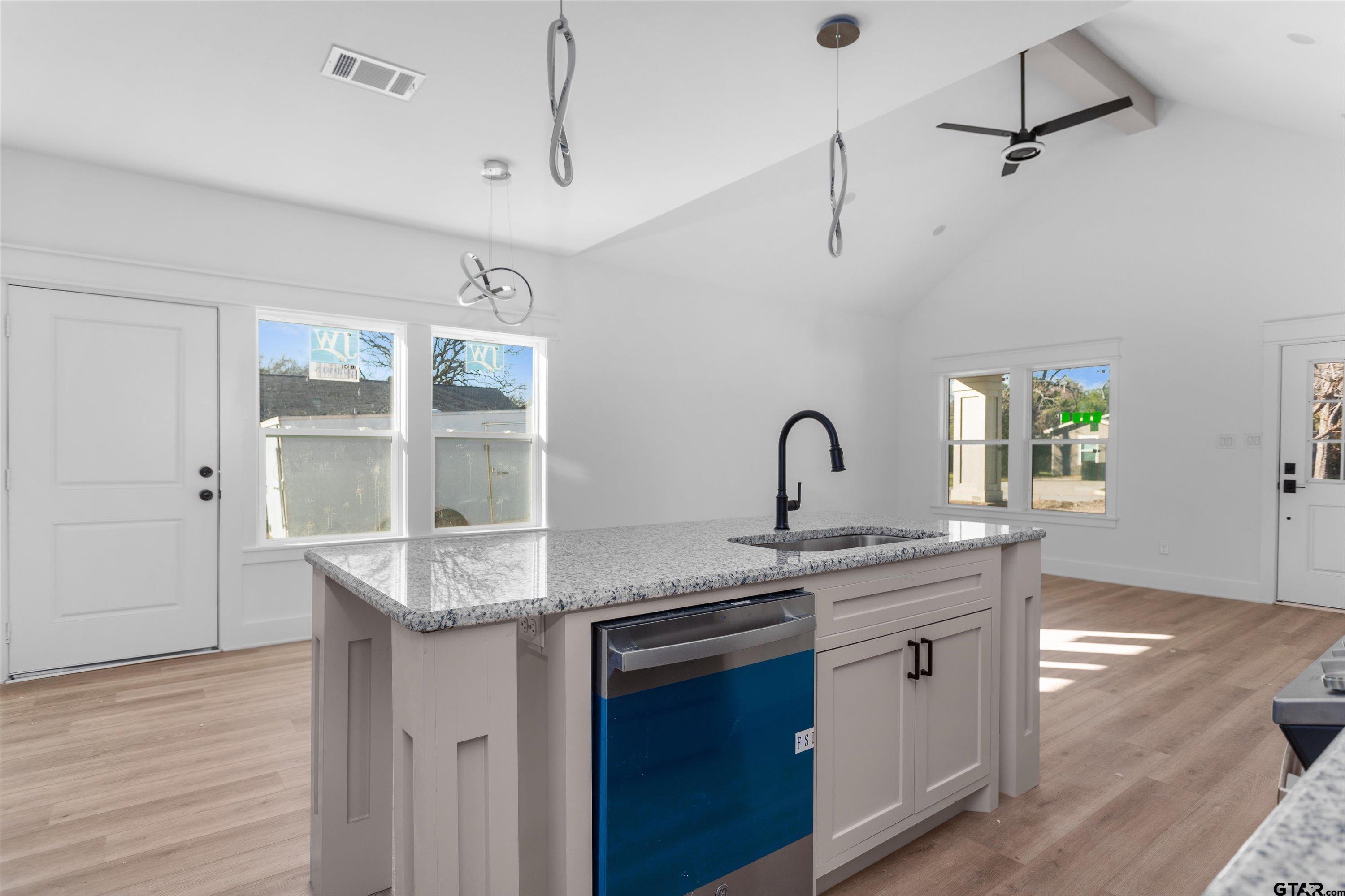 3026 Rose Tyler, TX 75701 - Photo 11 of 25 a kitchen with stainless steel appliances granite countertop a sink a stove and a wooden floors