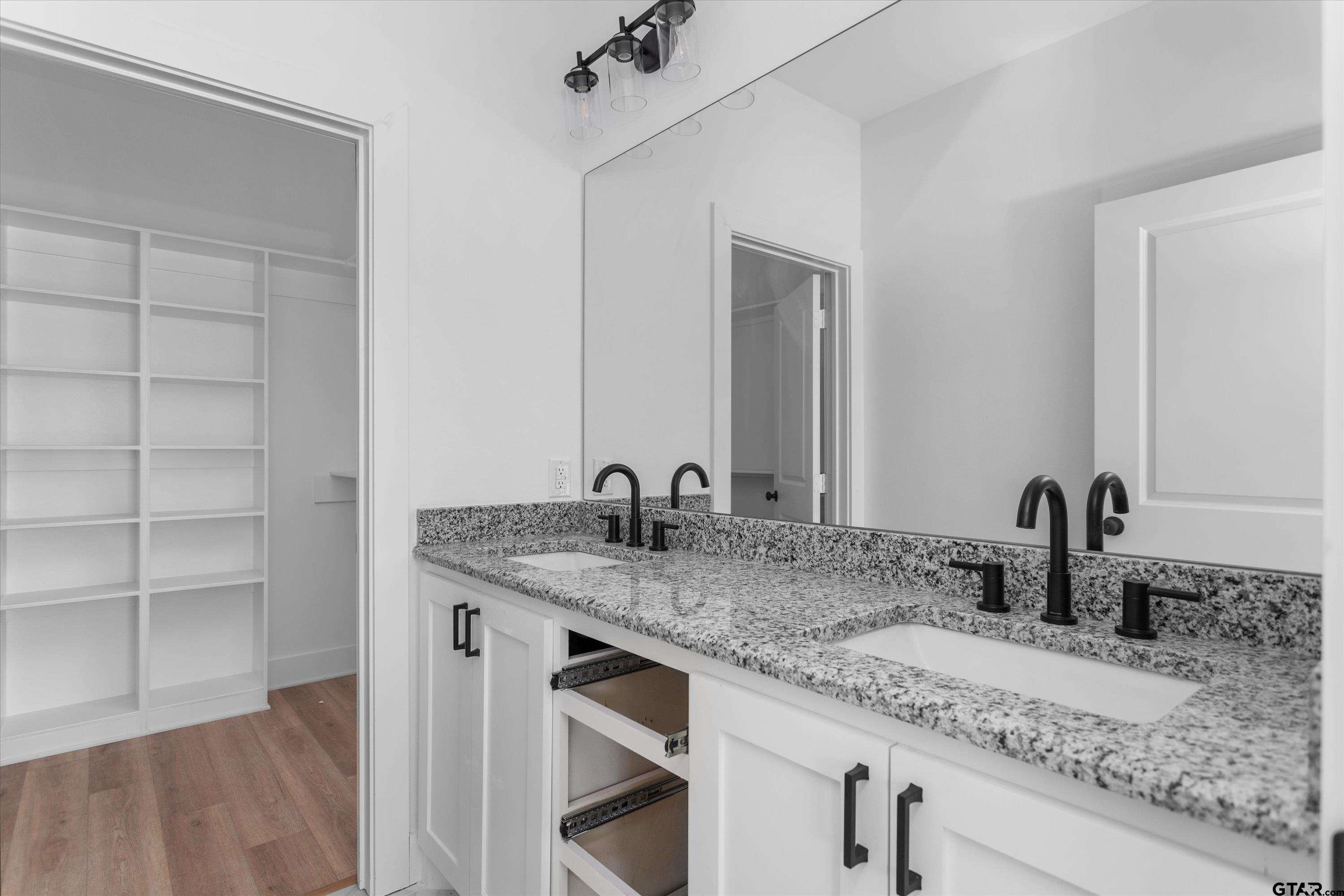3026 Rose Tyler, TX 75701 - Photo 17 of 25 a bathroom with a granite countertop sink and a mirror