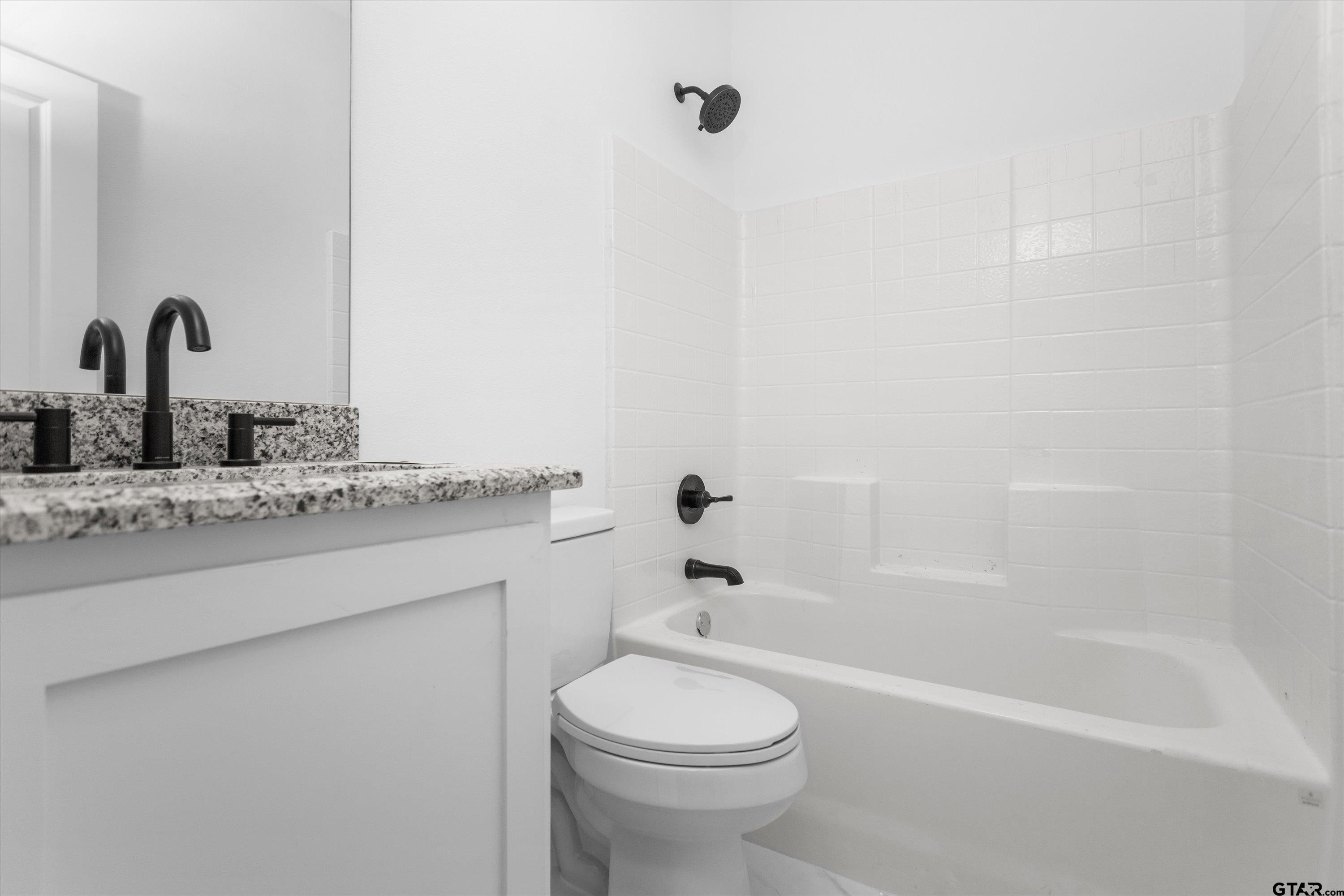 3026 Rose Tyler, TX 75701 - Photo 21 of 25 a bathroom with a granite countertop sink toilet and shower