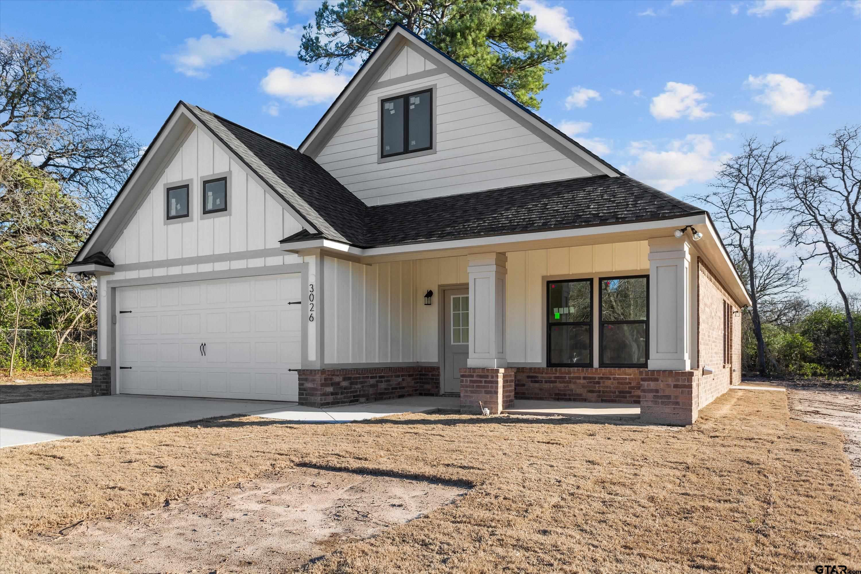 3026 Rose Tyler, TX 75701 - Photo 3 of 25 a front view of a house with a yard and garage