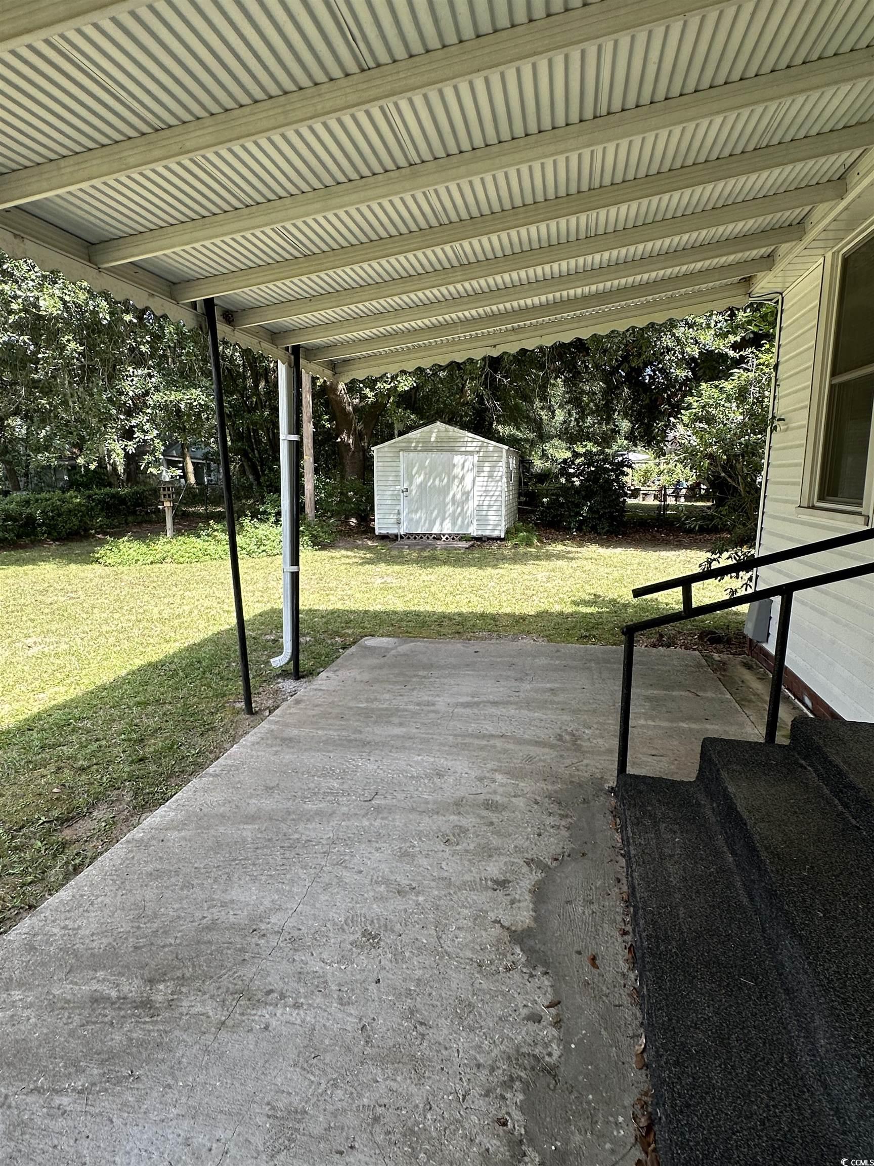 1357 Moss Street Georgetown, SC 29440 - Photo 4 of 13 View of patio featuring a storage unit