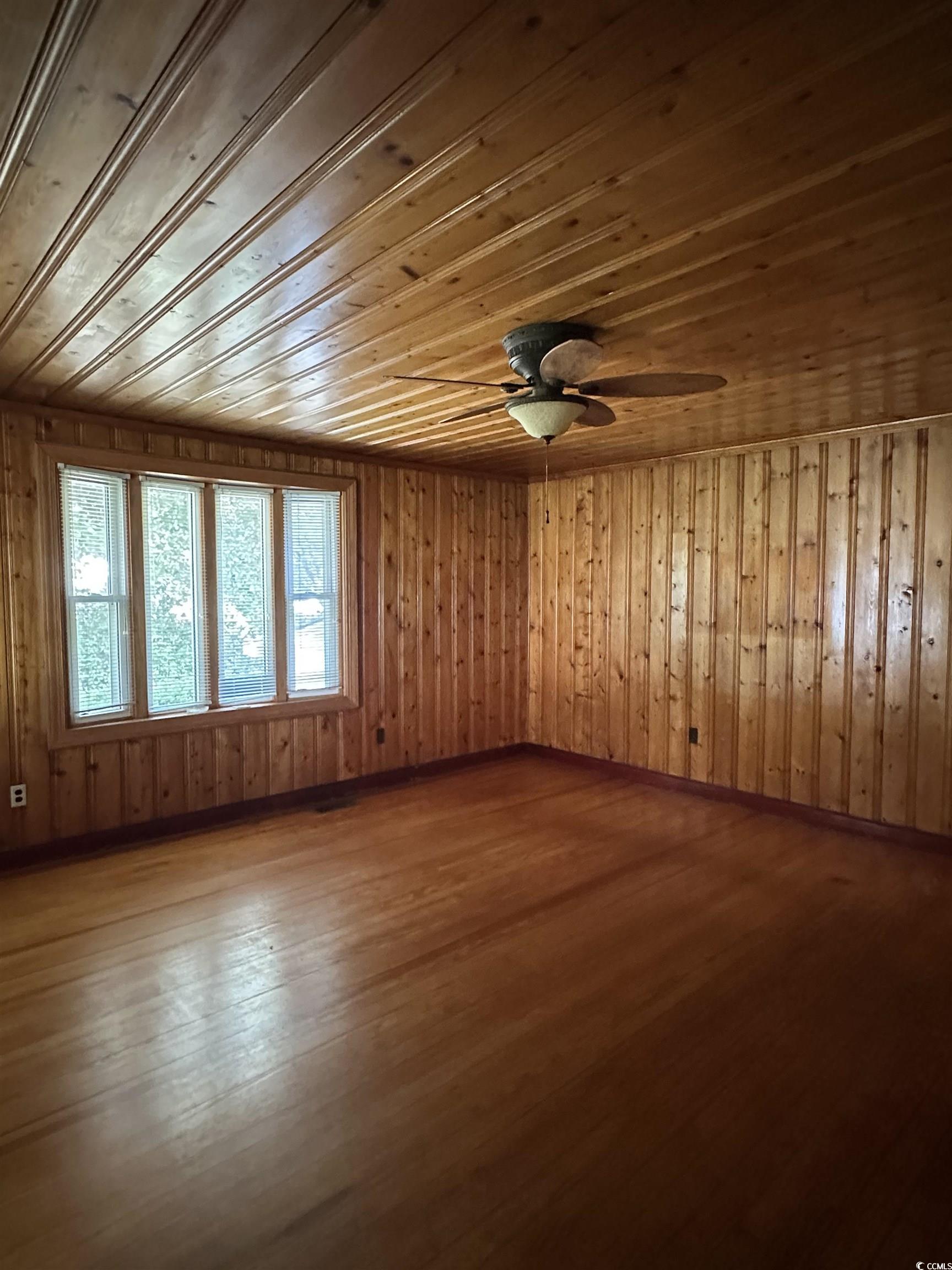 1357 Moss Street Georgetown, SC 29440 - Photo 8 of 13 Spare room with wooden ceiling, dark wood-style floors, wooden walls, and a ceiling fan