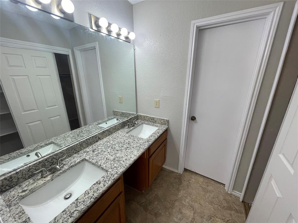 226 Wilderness Trail Mesquite, TX 75149 - Photo 12 of 12 a bathroom with a granite countertop sink and a mirror