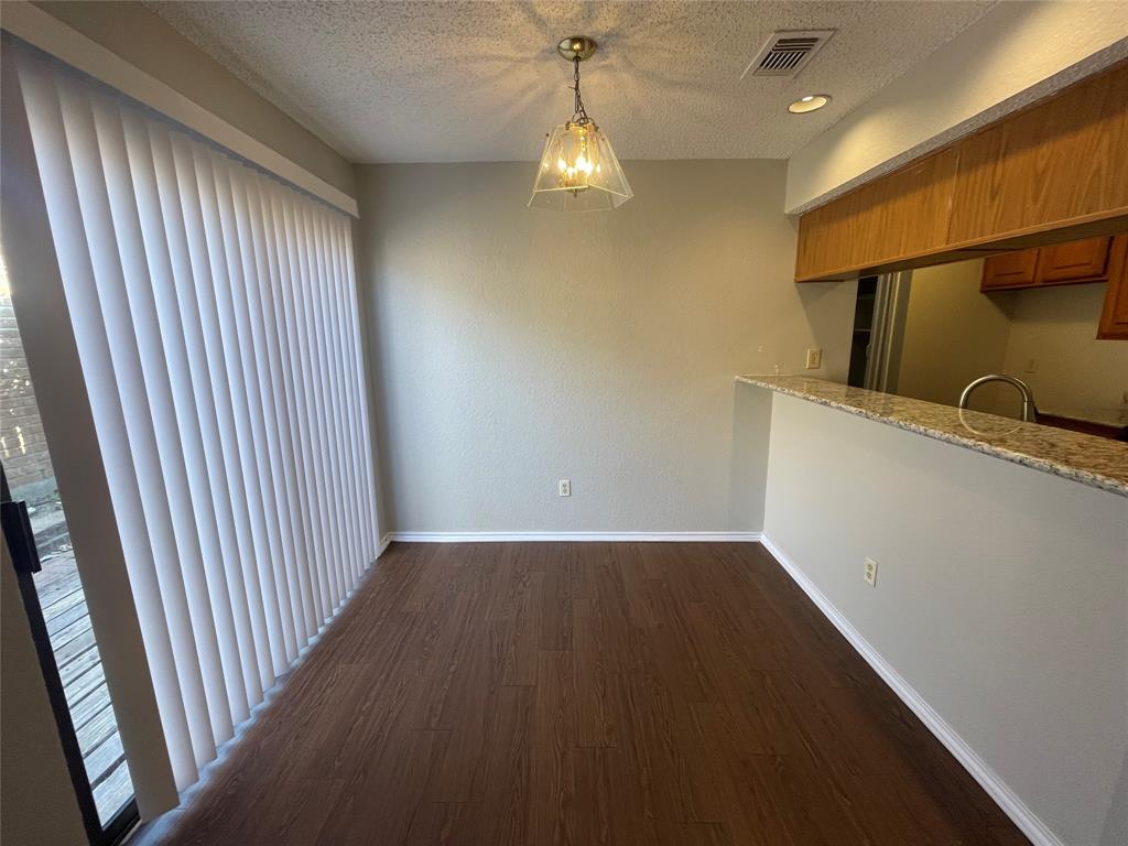 226 Wilderness Trail Mesquite, TX 75149 - Photo 4 of 12 wooden floor in an empty room with a window