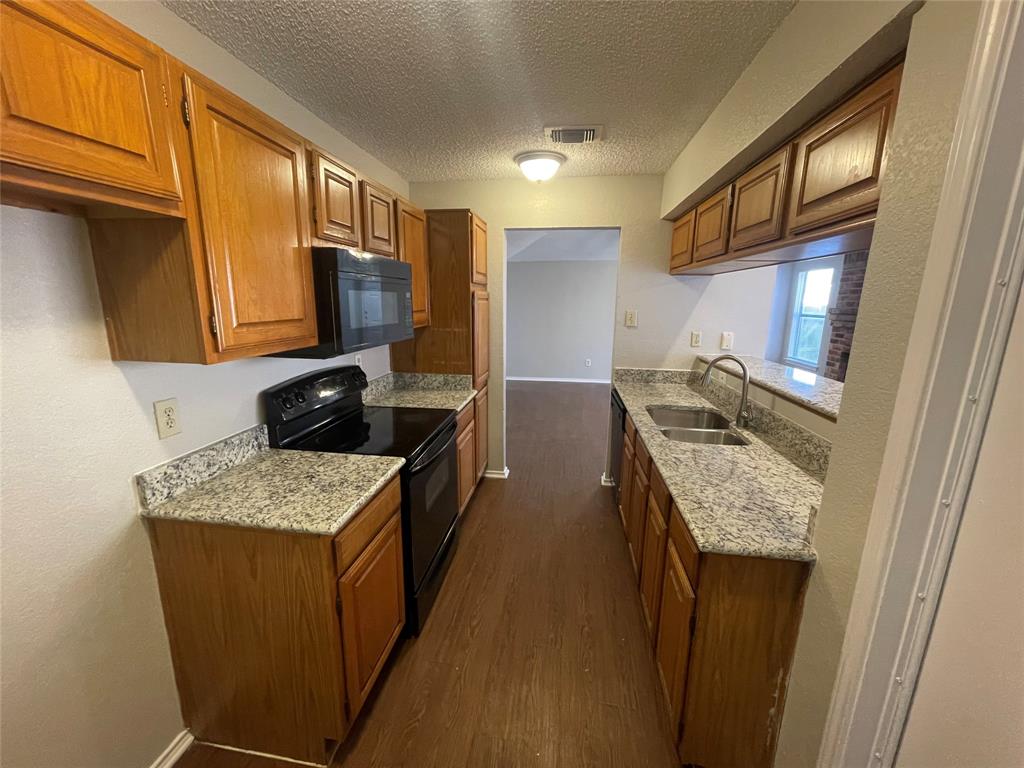 226 Wilderness Trail Mesquite, TX 75149 - Photo 6 of 12 a kitchen with stainless steel appliances granite countertop a sink stove and refrigerator