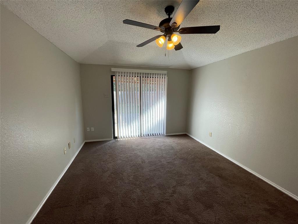 226 Wilderness Trail Mesquite, TX 75149 - Photo 7 of 12 an empty room with a window and a ceiling fan