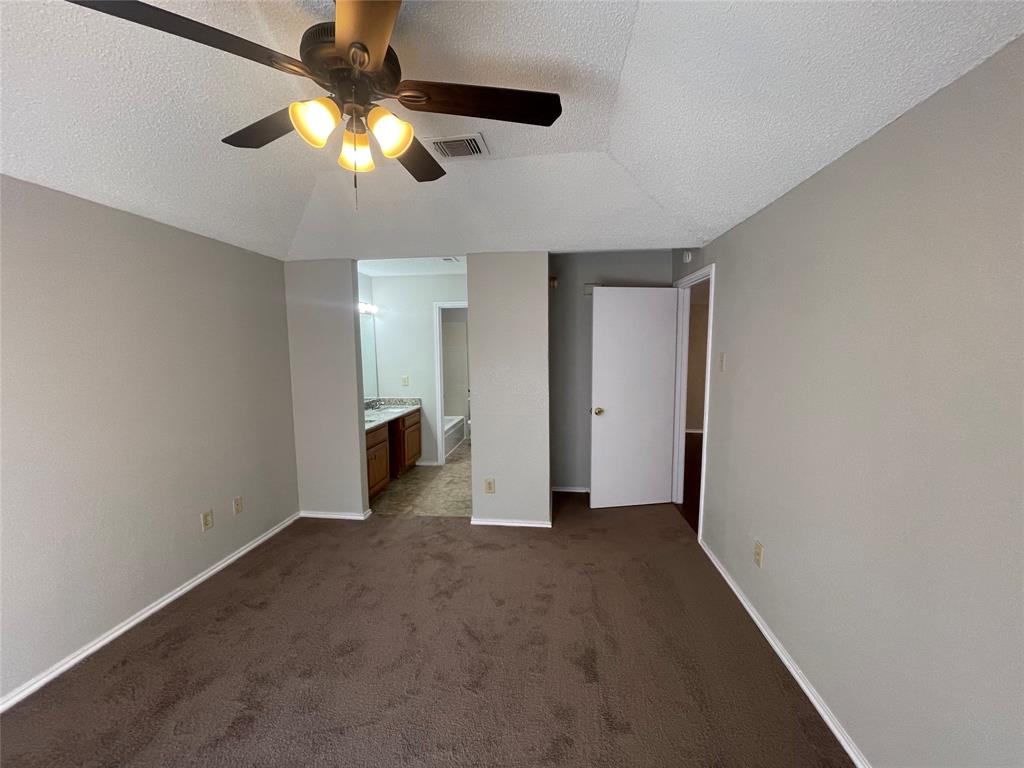 226 Wilderness Trail Mesquite, TX 75149 - Photo 8 of 12 an empty room with closet and a chandelier fan