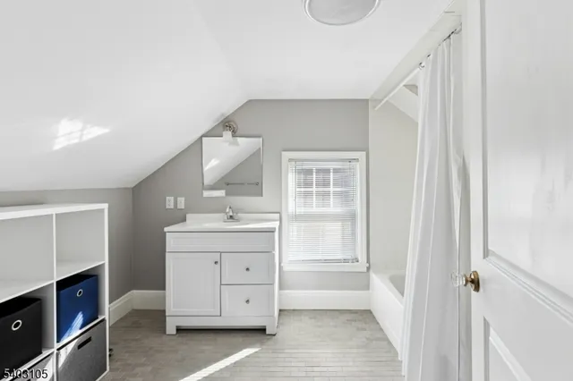 a spacious bathroom with a granite countertop sink and a mirror