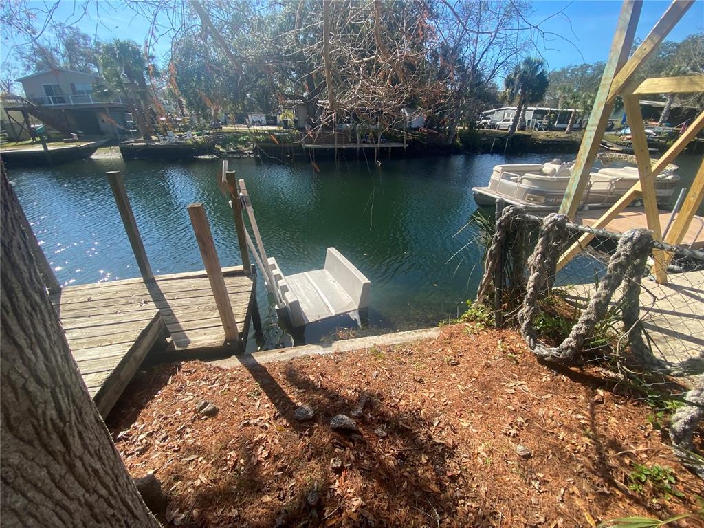 6427 West Richard Drive Weeki Wachee, FL 34607 - Photo 31 of 35 a backyard of a house with a lake view