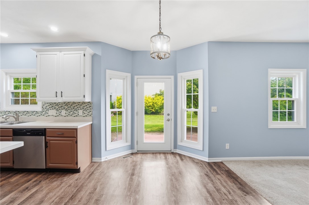 10 Chase Court Springboro, OH 45066 - Photo 18 of 75 This bright kitchen and dining area features abundant natural light and seamless outdoor access.