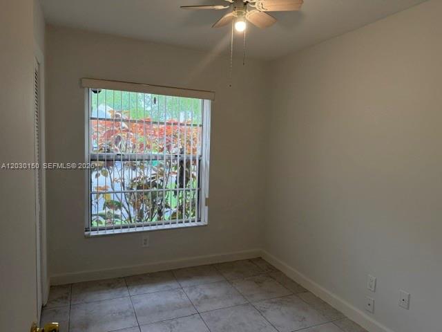 11206 Southwest 125th Place, Unit 11206 Miami, FL 33186 - Photo 9 of 15 an empty room with a window