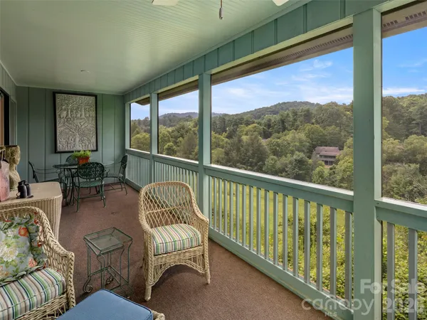 a balcony with furniture and a window