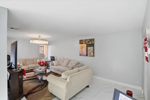a view of a hallway with wooden floor and entryway
