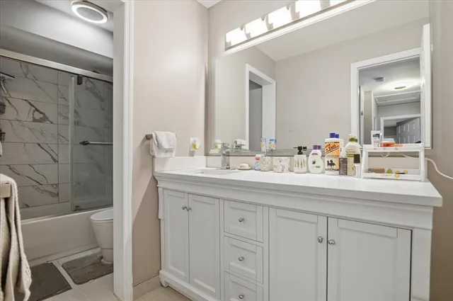 a bedroom with a bed and a ceiling fan