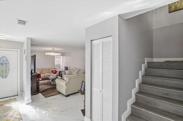 a living room with furniture and flowers