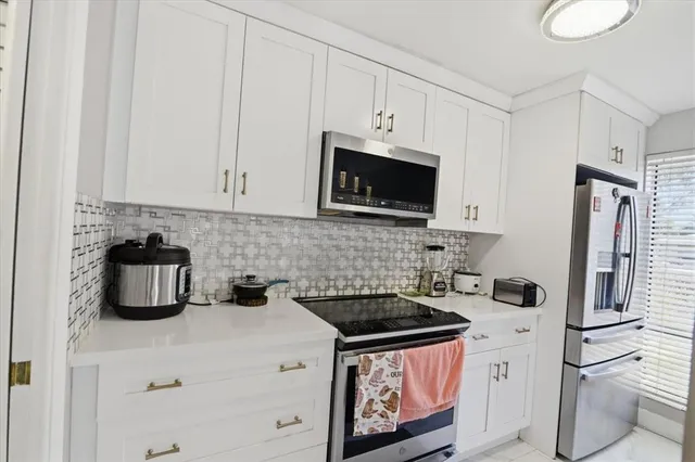 a bathroom with a sink vanity mirror and toilet