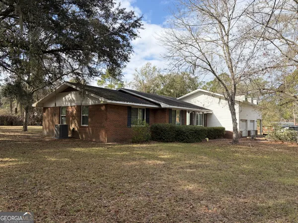 a house that has a tree in front of it