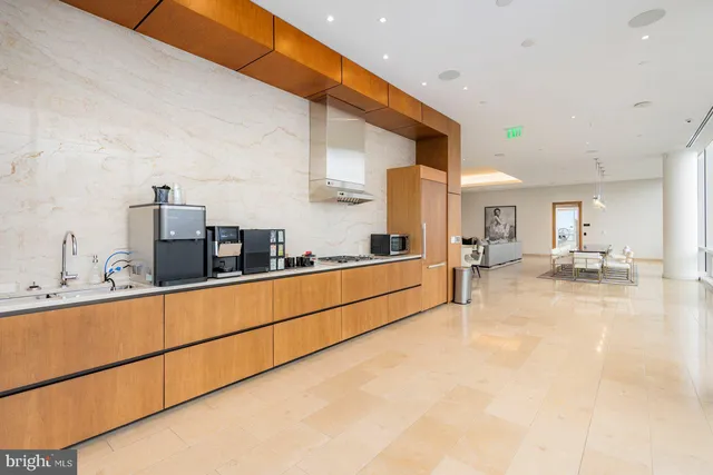 a view of kitchen with stainless steel appliances a sink and cabinets