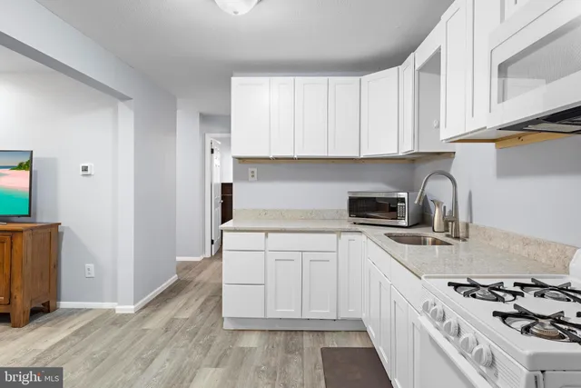 a kitchen with cabinets and appliances