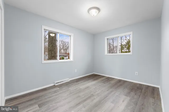 a view of room with window and wooden floor