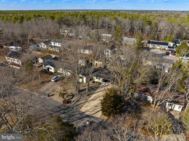 a view of a yard with wooden fence