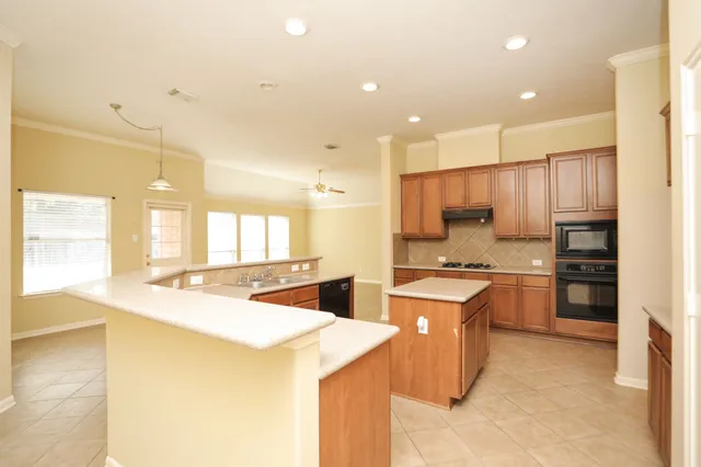 a kitchen with a stove a refrigerator and a sink