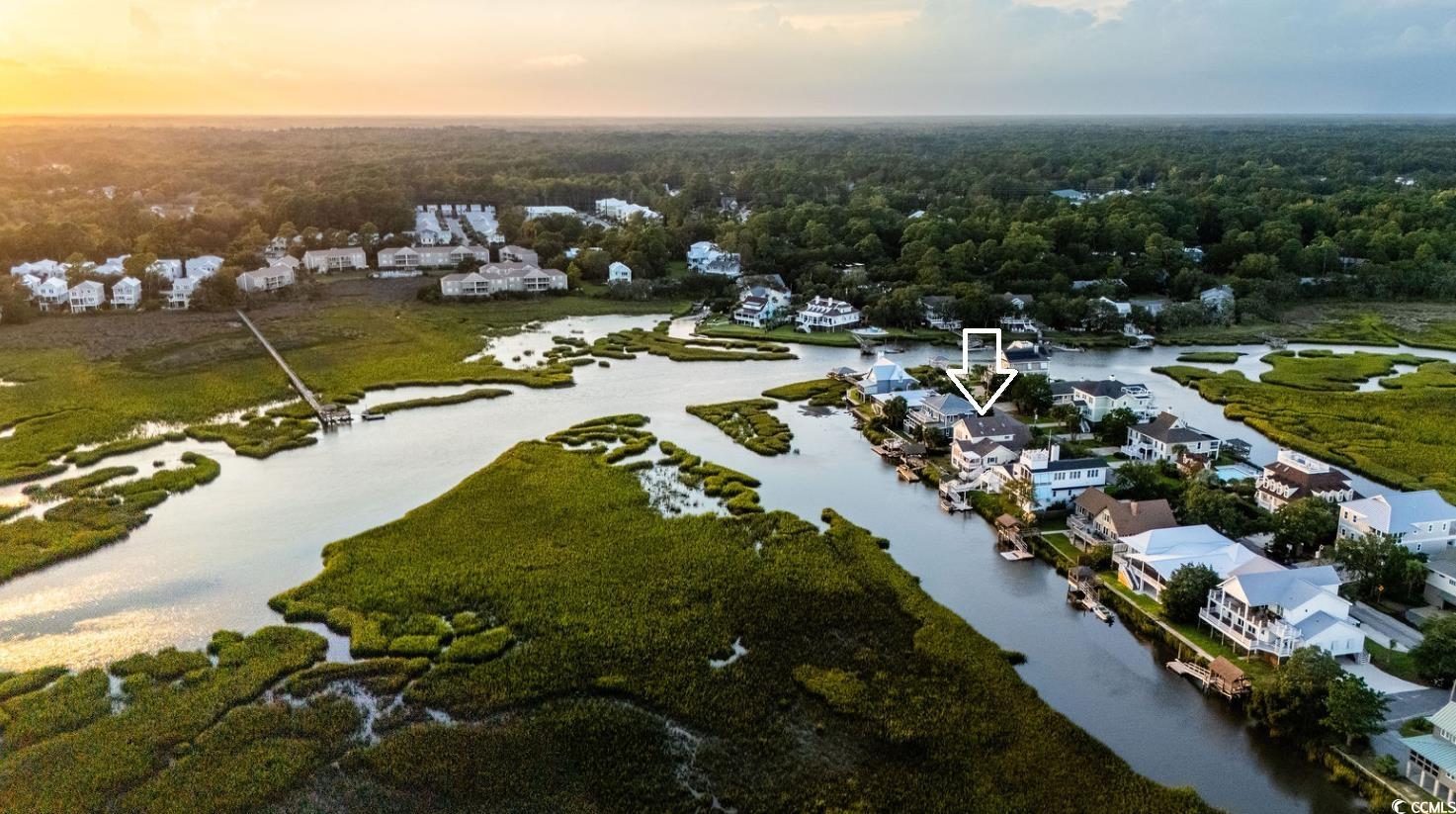 75 Marsh Hen Drive Pawleys Island, SC 29585 - Photo 11 of 26 Aerial view at dusk of a forest view and a residential view
