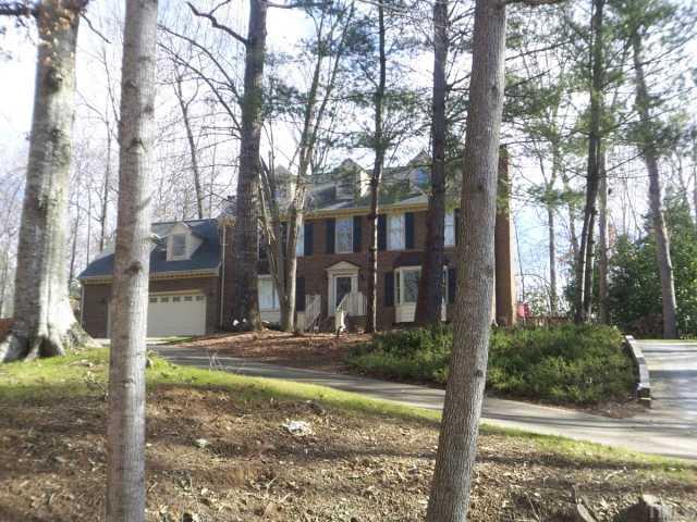 11605 Appaloosa Run West Raleigh, NC 27613 - Photo 1 of 12 a view of a house with trees in the background