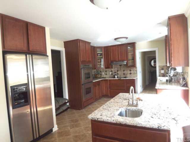 11605 Appaloosa Run West Raleigh, NC 27613 - Photo 2 of 12 a kitchen with stainless steel appliances granite countertop a refrigerator and a sink