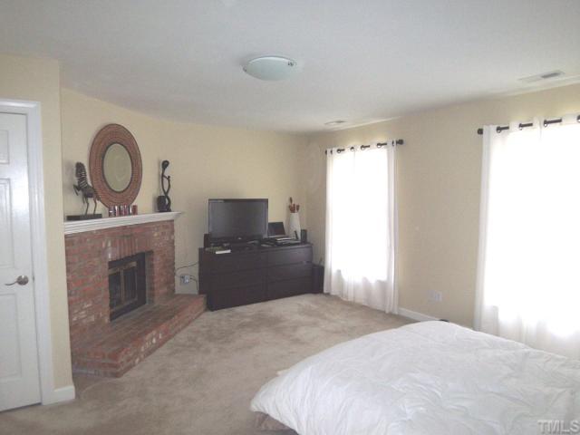 11605 Appaloosa Run West Raleigh, NC 27613 - Photo 4 of 12 a bedroom with a bed and a television