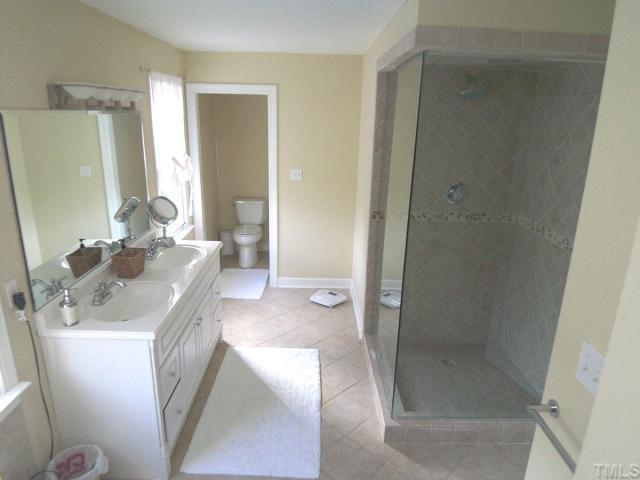 11605 Appaloosa Run West Raleigh, NC 27613 - Photo 5 of 12 a bathroom with a sink a toilet and shower