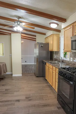 a kitchen with granite countertop a stove and a refrigerator