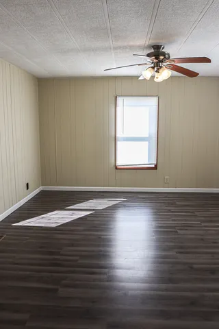 a view of a room with wooden floor and a window