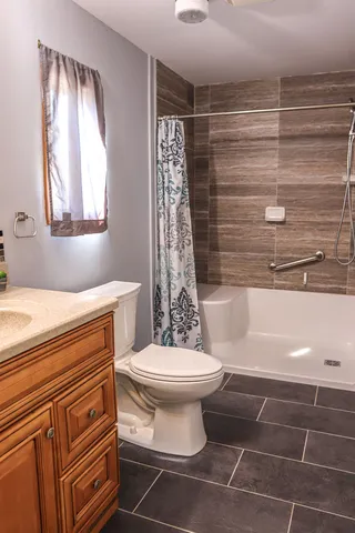 a bathroom with a shower a toilet and sink