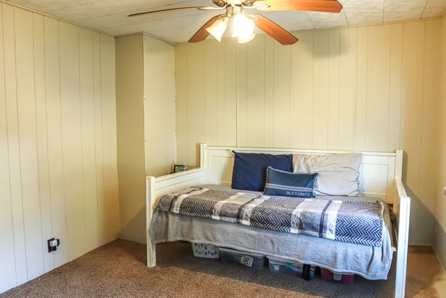 a bedroom with a bed and chandelier