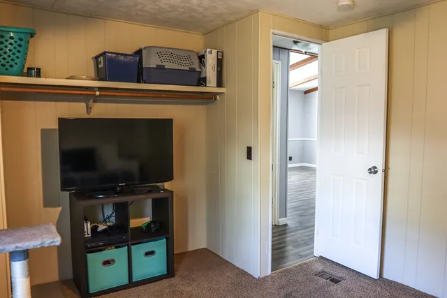 a view of room with flat screen tv and washer