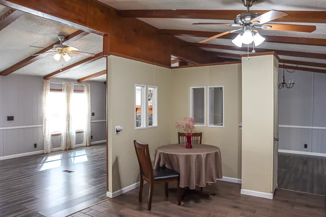 a view of a dining room with furniture and wooden floor
